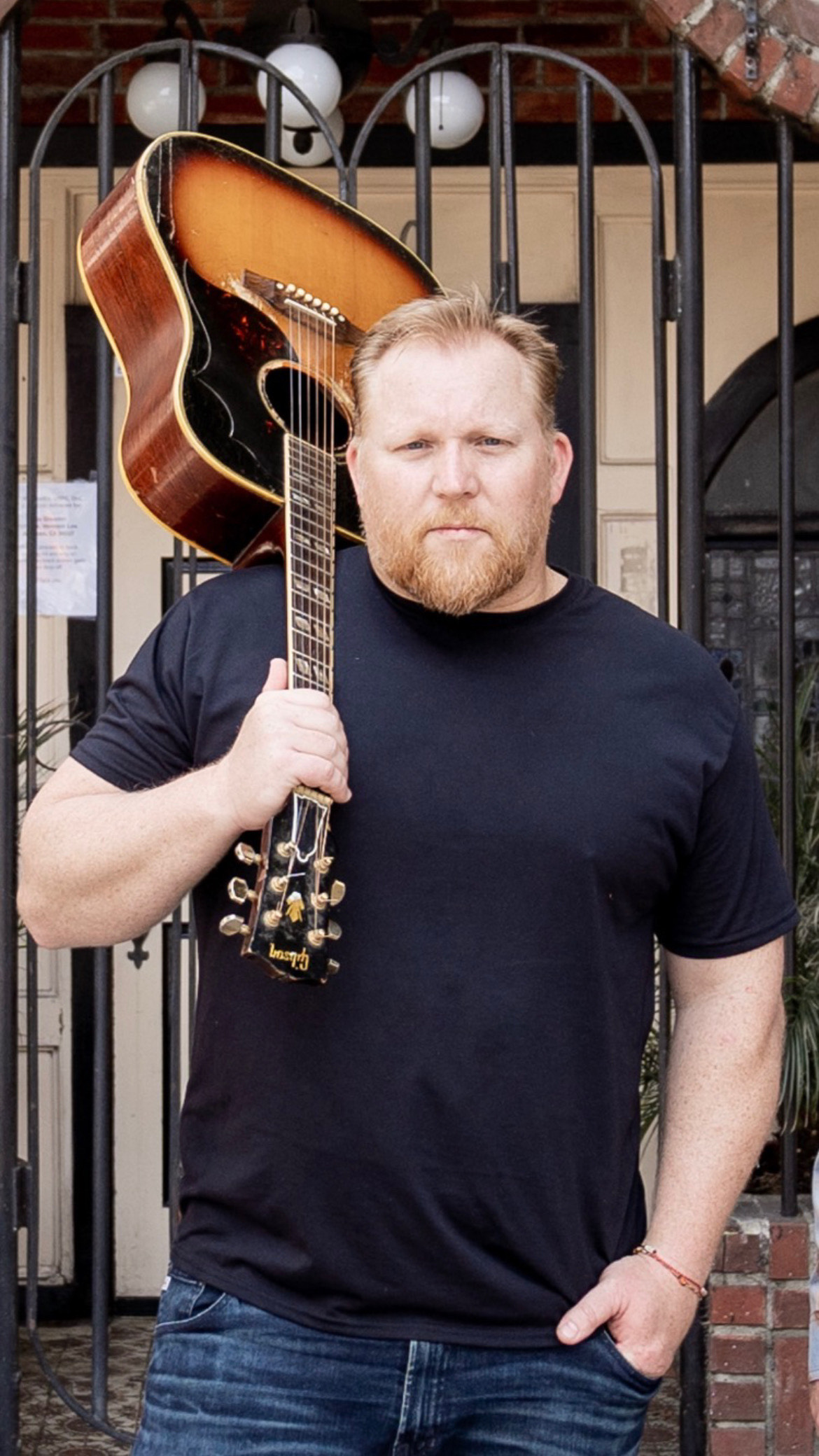 Gronsky with vintage Gibson acoustic guitar